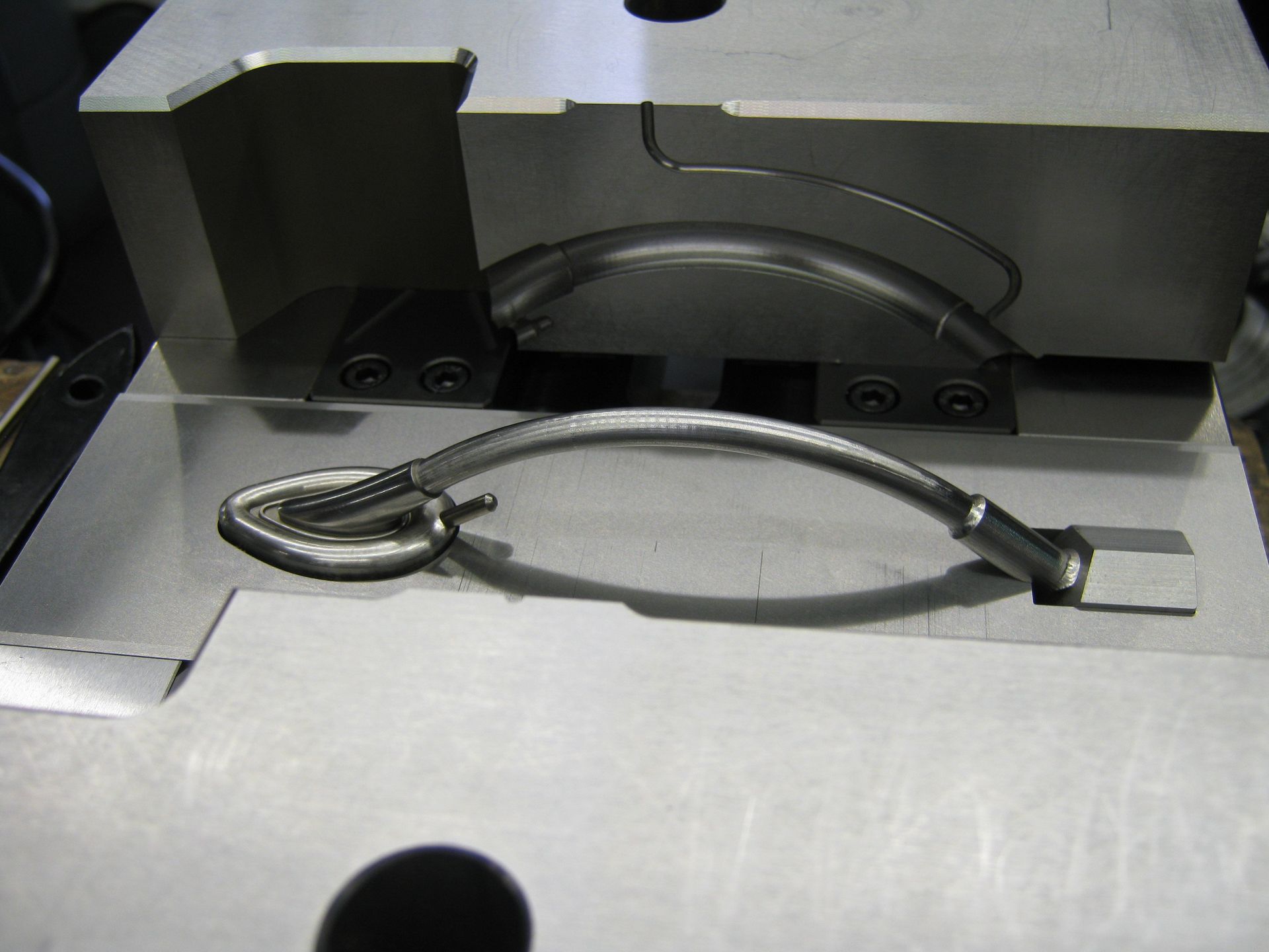 A piece of metal with a rope coming out of it