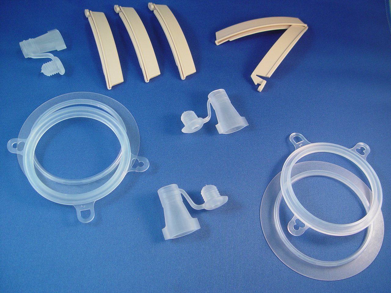 A bunch of clear plastic objects on a blue surface