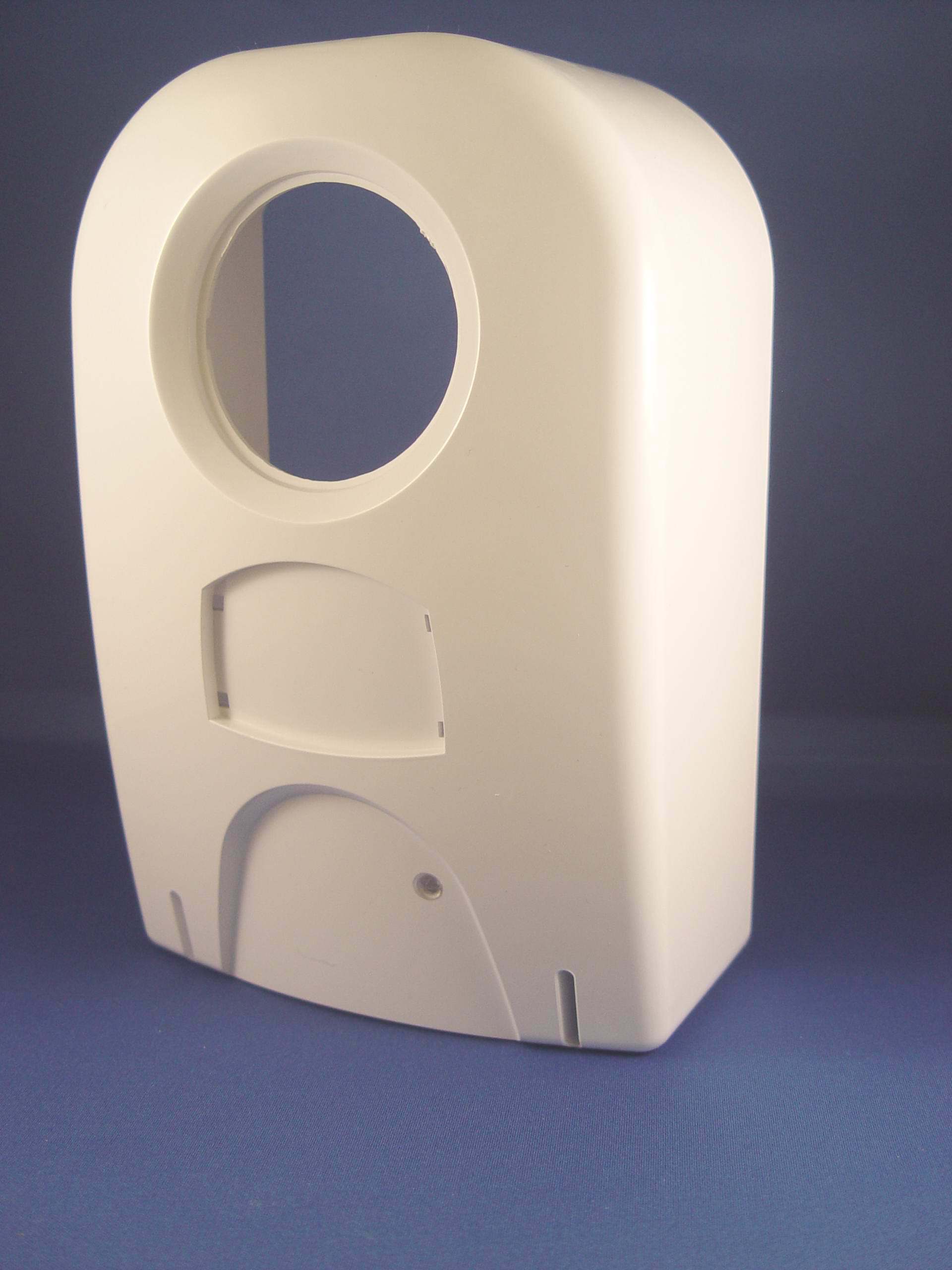 A white object with a hole in the middle on a blue surface