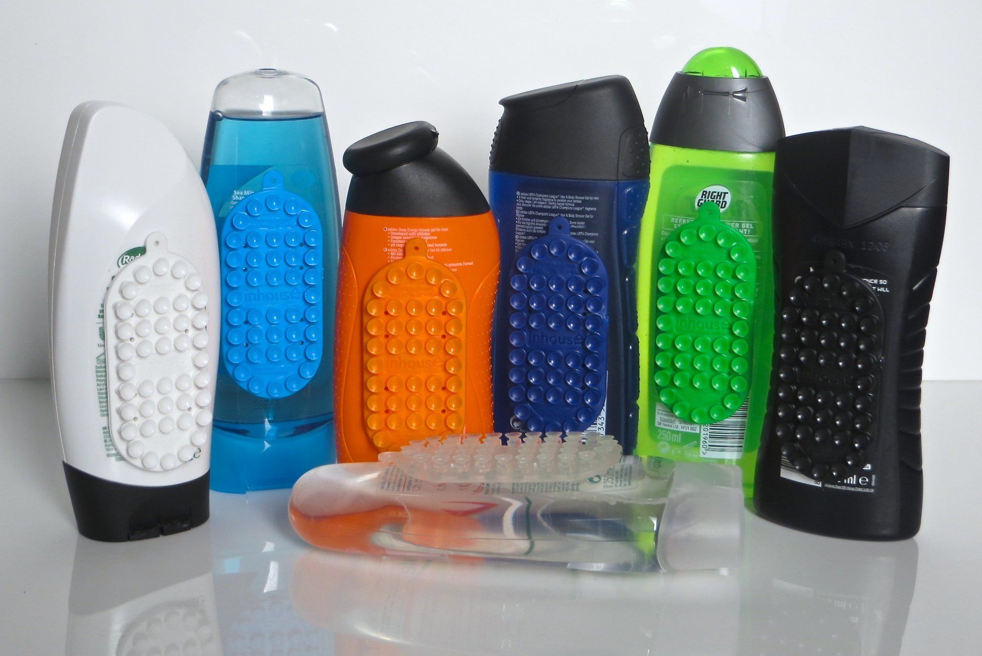 A bunch of different colored bottles are lined up on a table