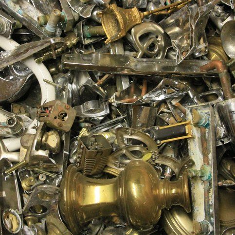 Pile of assorted brass and chrome hardware scraps.