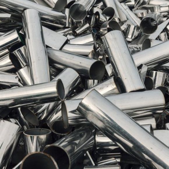 Pile of shiny, cylindrical metal tubes, likely scrap or industrial material.