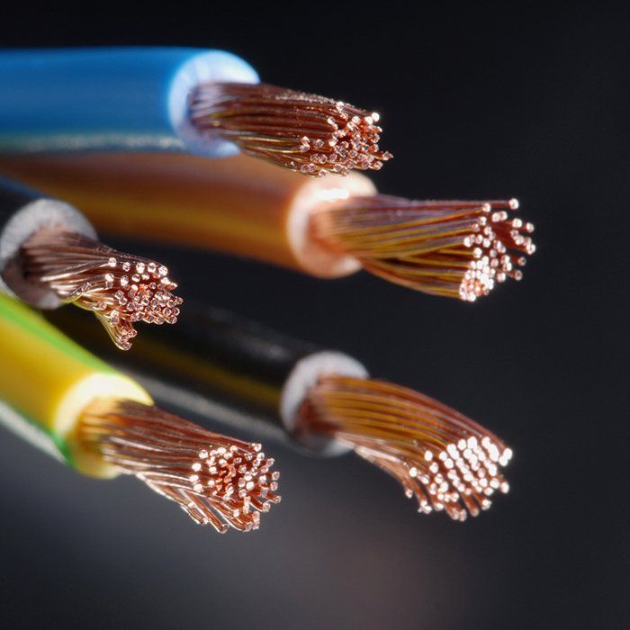 Close-up of multicolored electrical wires with exposed copper strands.