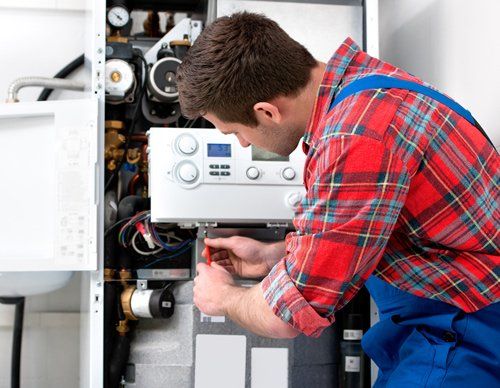 Technician Servicing Heating Boiler — Wimauma, FL — Reedy Plumbing Technician Servicing Heating Boiler — Wimauma, FL — Reedy Plumbing
