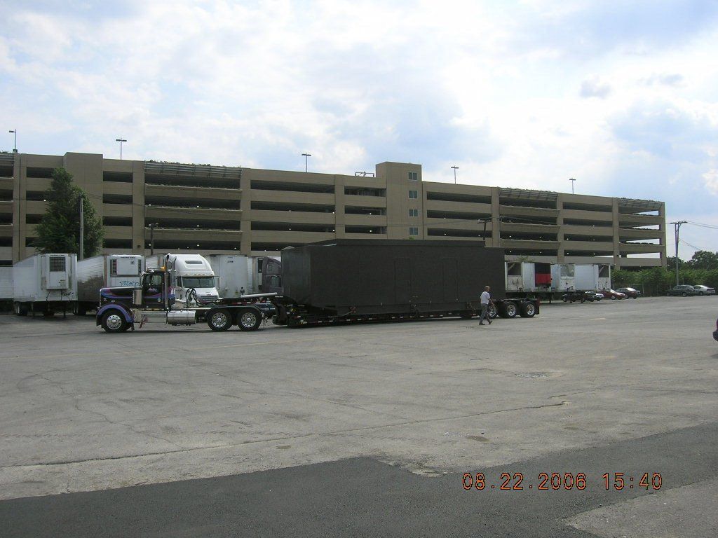 A parking lot with a large building in the background