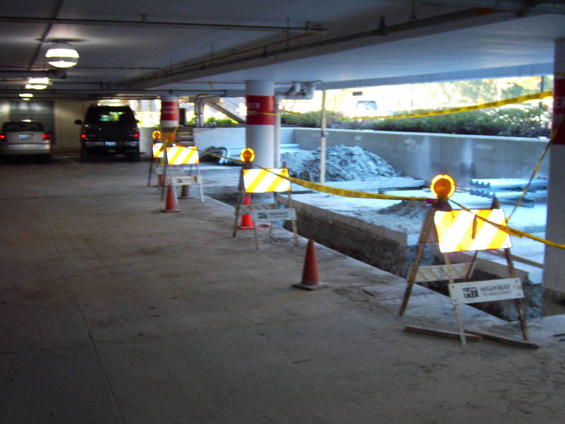 A row of construction barriers in a parking garage
