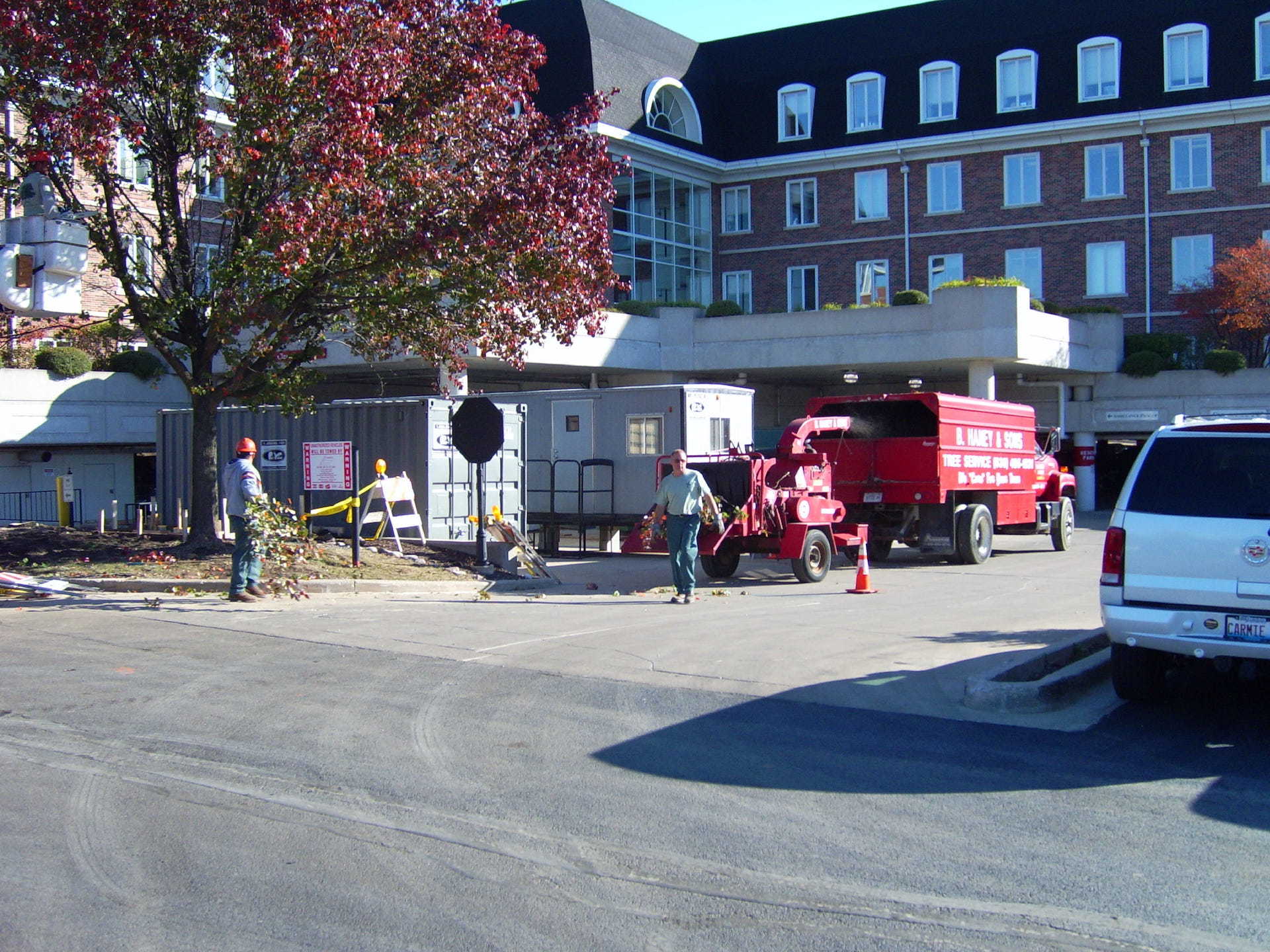 A ford truck is parked in front of a large building
