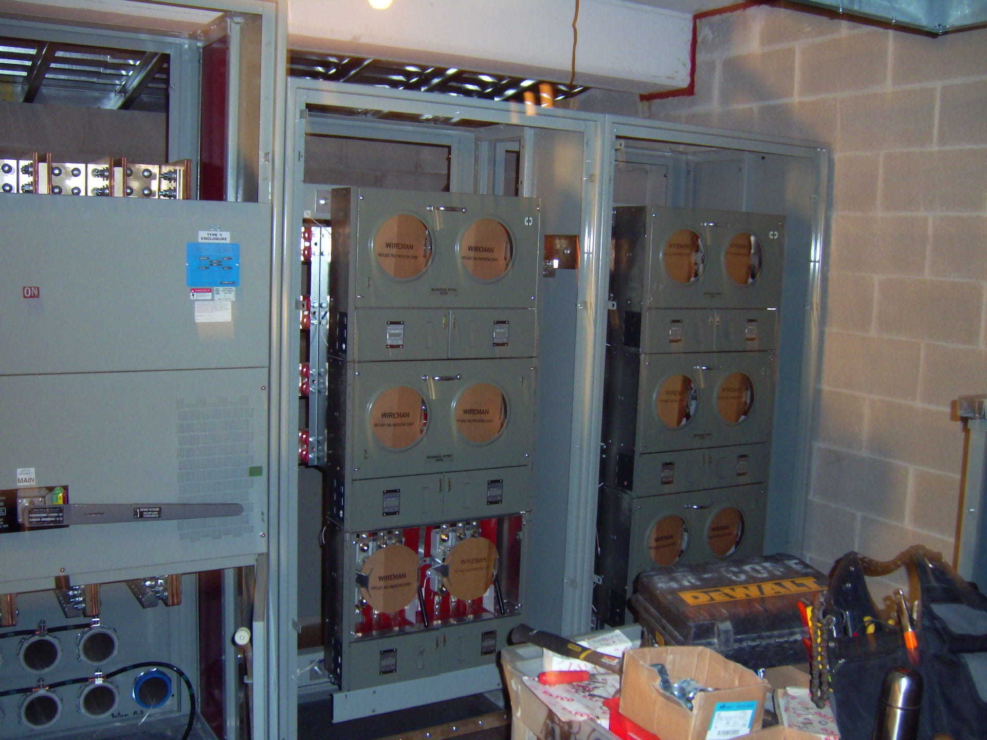A room with a bunch of electrical boxes and a brick wall