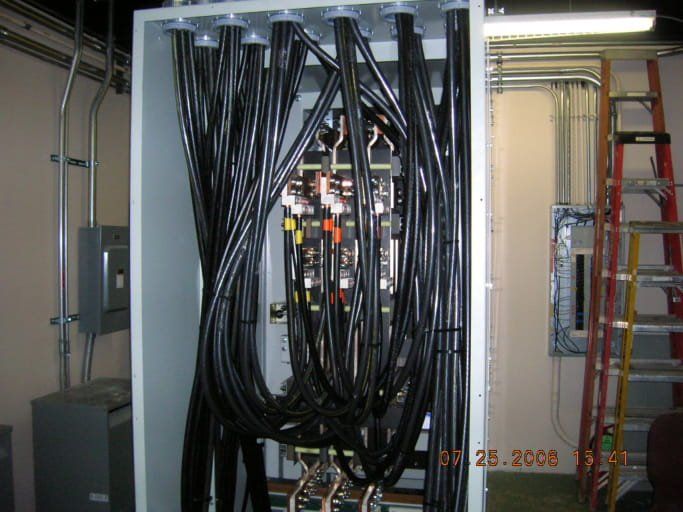 A bunch of wires are connected to a white box