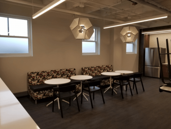 A room with tables and chairs and a couch