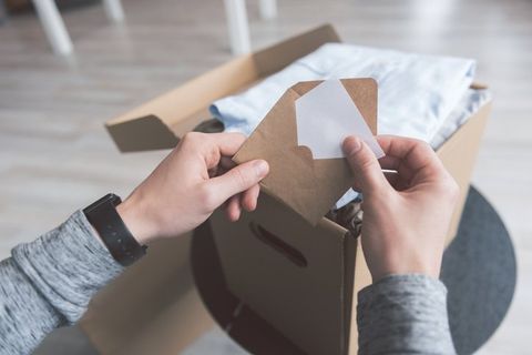 Commercial Delivery — Woman Receiving Parcel from Courier at Home in Huntsville, AL Commercial Delivery — Woman Receiving Parcel from Courier at Home in Huntsville, AL
