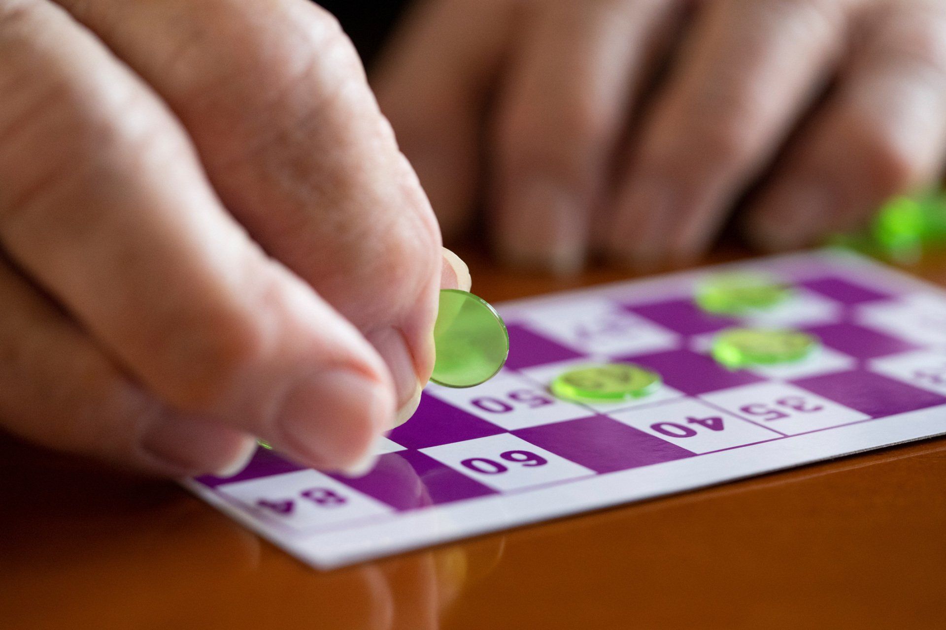 Close Up Photo Of A Man Playing Bingo Card — Billings, MT — TLC Assisted Living
