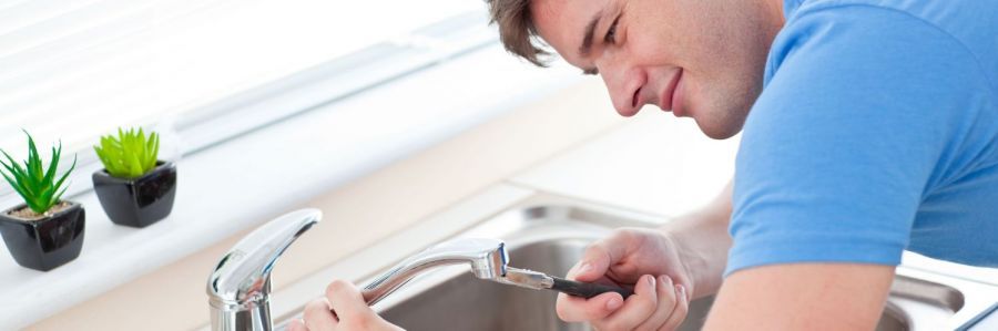 Plumber fixing a faucet