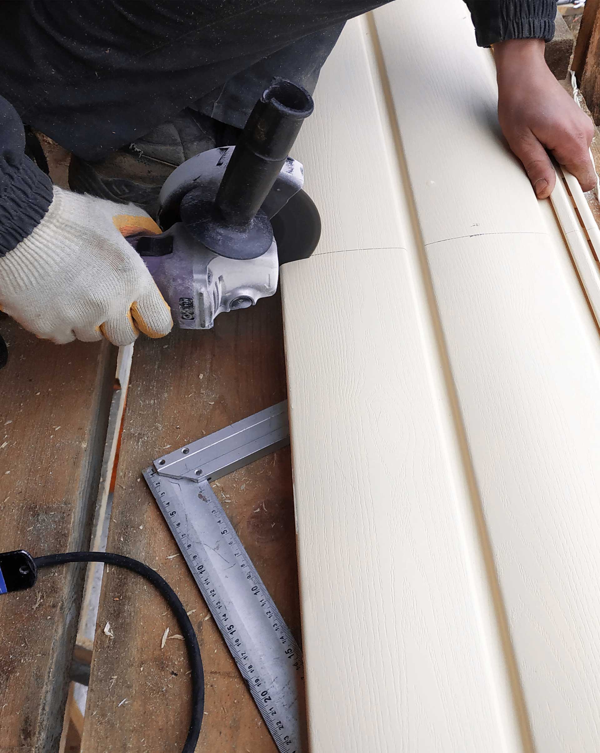 Vinyl Siding Cutting — Powells Point, NC — Coastal Roofing & Siding Inc Vinyl Siding Cutting — Powells Point, NC — Coastal Roofing & Siding Inc