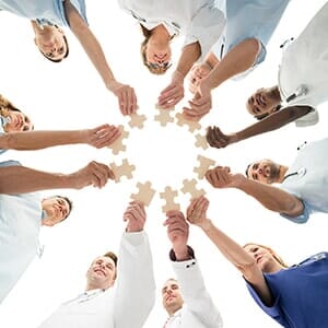 Medical Team Joining Jigsaw Pieces - medical home in Elmhurst, NY Medical Team Joining Jigsaw Pieces - medical home in Elmhurst, NY