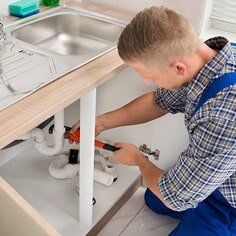 Plumber Fixing Sink Pipe — Emergency Repair Service in Tallahassee, FL Plumber Fixing Sink Pipe — Emergency Repair Service in Tallahassee, FL