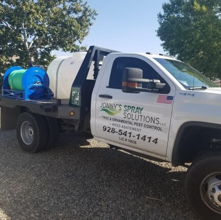 White truck with tank and spray equipment; 