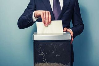 Off-site Document Shredding — Businessman Shredding Document in Goffstown, NH Off-site Document Shredding — Businessman Shredding Document in Goffstown, NH