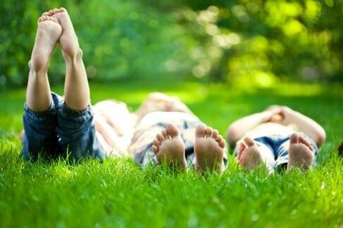 Children laying on the grass — Cleaner in Chowchilla, CA