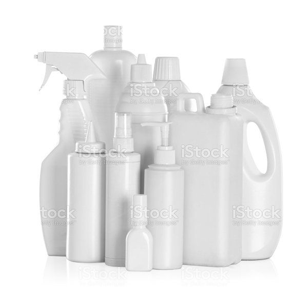 A group of white plastic bottles and spray bottles on a white background.