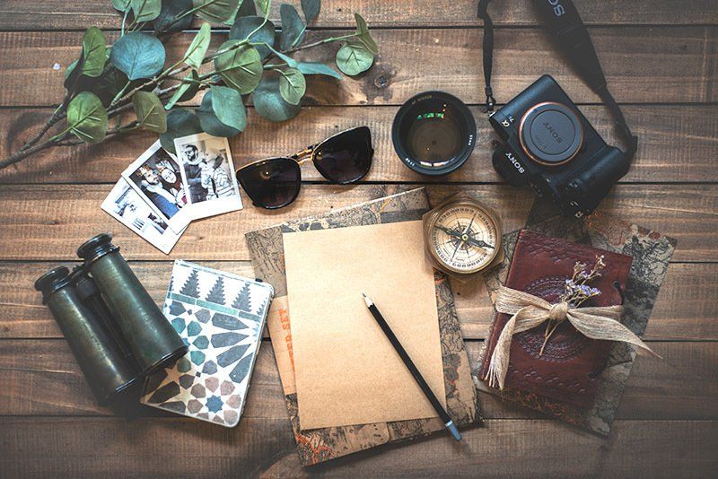 travel items such as sunglasses, camera, note paper