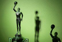 A sporting trophy in the shape of a sportsman holding a football aloft