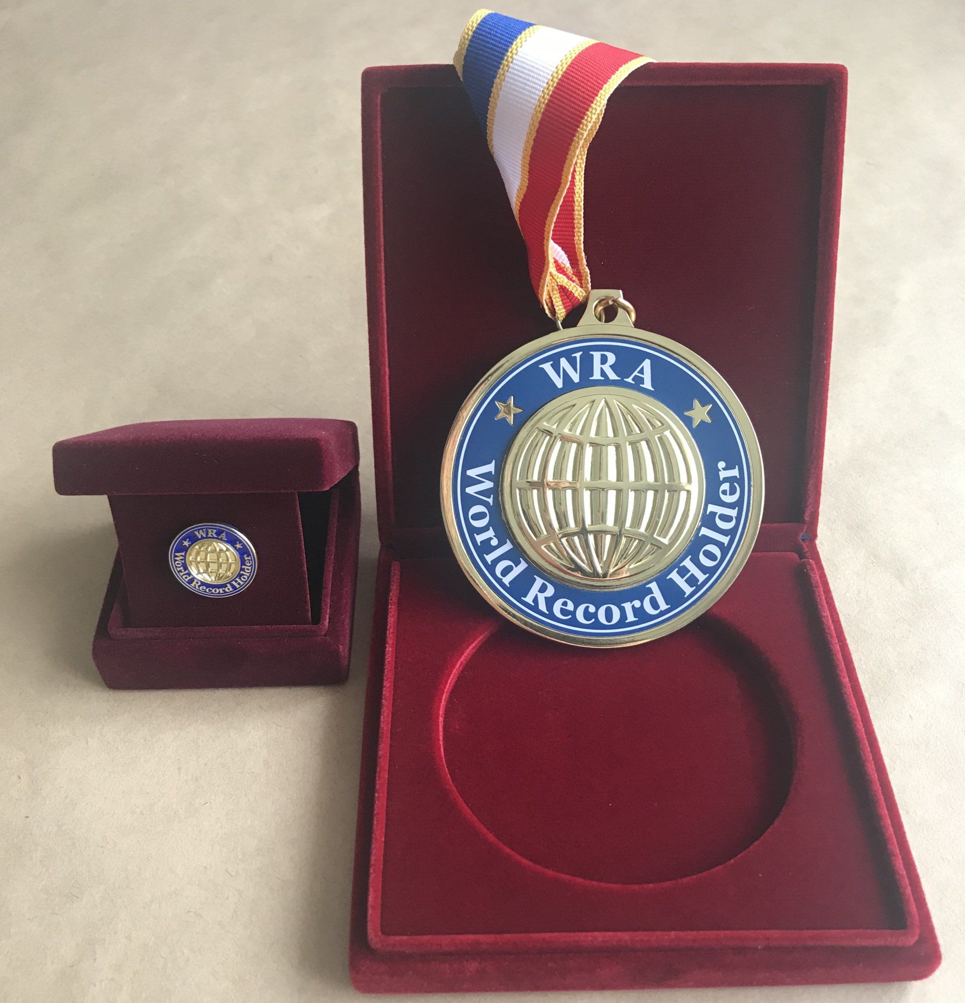 medal and Pin for Youngest person to back flip on a scooter to timber ramp: world record set by Jamie Russell