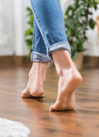 Young Woman Walking in the House on the Warm Floor — Oklahoma City, OK — Temple Johnson Floor Company Young Woman Walking in the House on the Warm Floor — Oklahoma City, OK — Temple Johnson Floor Company