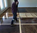 Man Cleaning Hardwood Flooring — Oklahoma City, OK — Temple Johnson Floor Company Man Cleaning Hardwood Flooring — Oklahoma City, OK — Temple Johnson Floor Company
