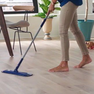Woman Mopping Wooden Floor — Oklahoma City, OK — Temple Johnson Floor Company
