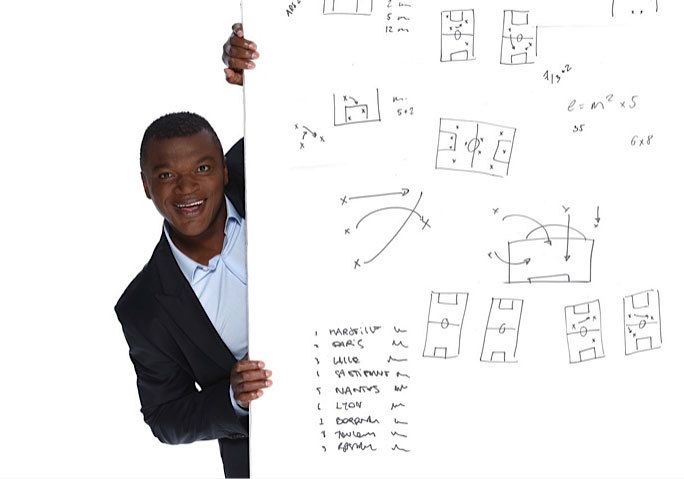 marcel behind a white board