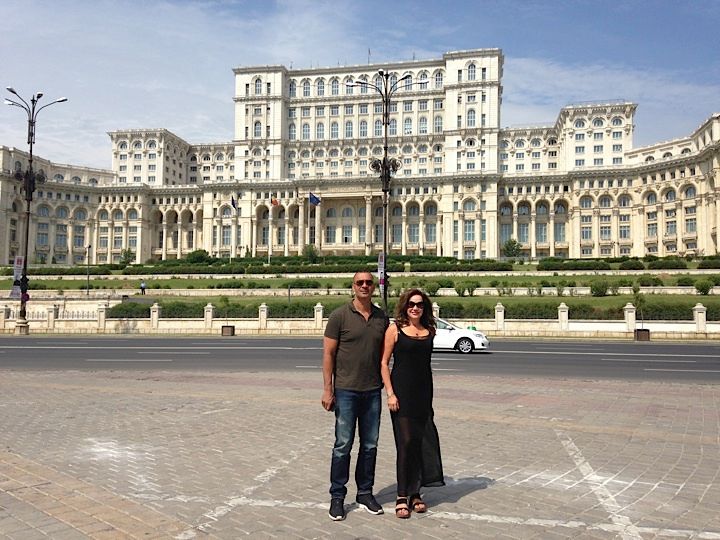 corrinne and ruud posing in front of the People's Pallace in Romania