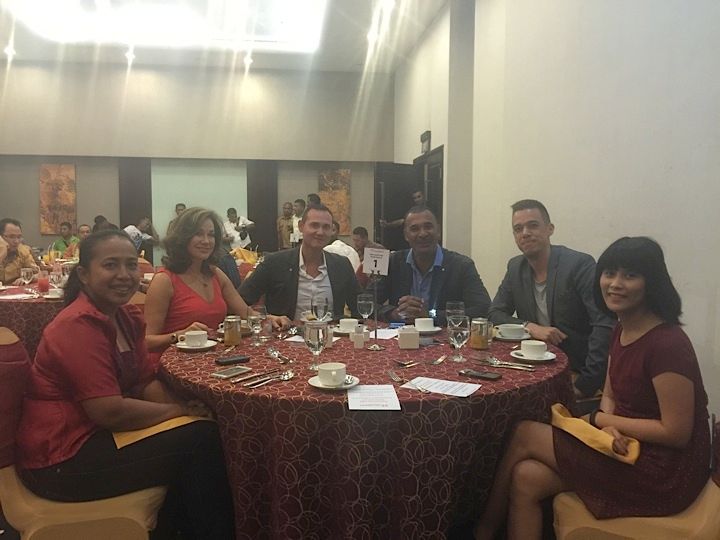 corrinne with ruud at a round table with their friends