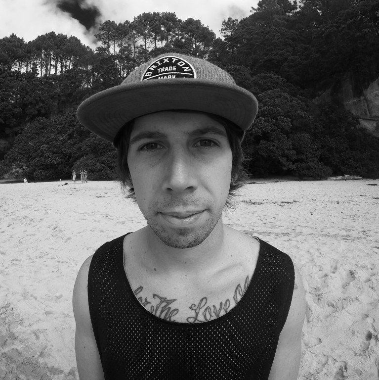 A man wearing a hat and a tank top with the word love on his chest