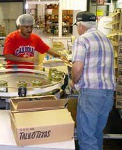 Team Members Packing Boxes of Crisp Okra Pickles