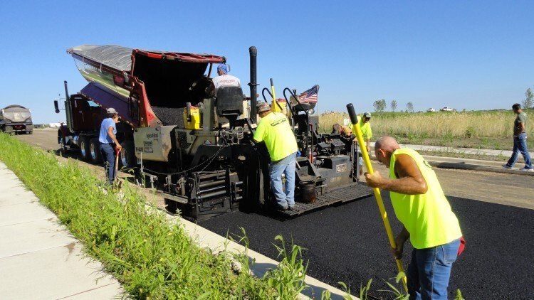 Workers Operating Asphalt Paver Machine — East Peoria, IL — Tazewell County Asphalt Company