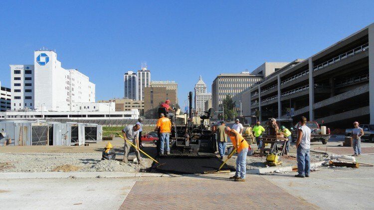 Workers Levelling Asphalt — East Peoria, IL — Tazewell County Asphalt Company