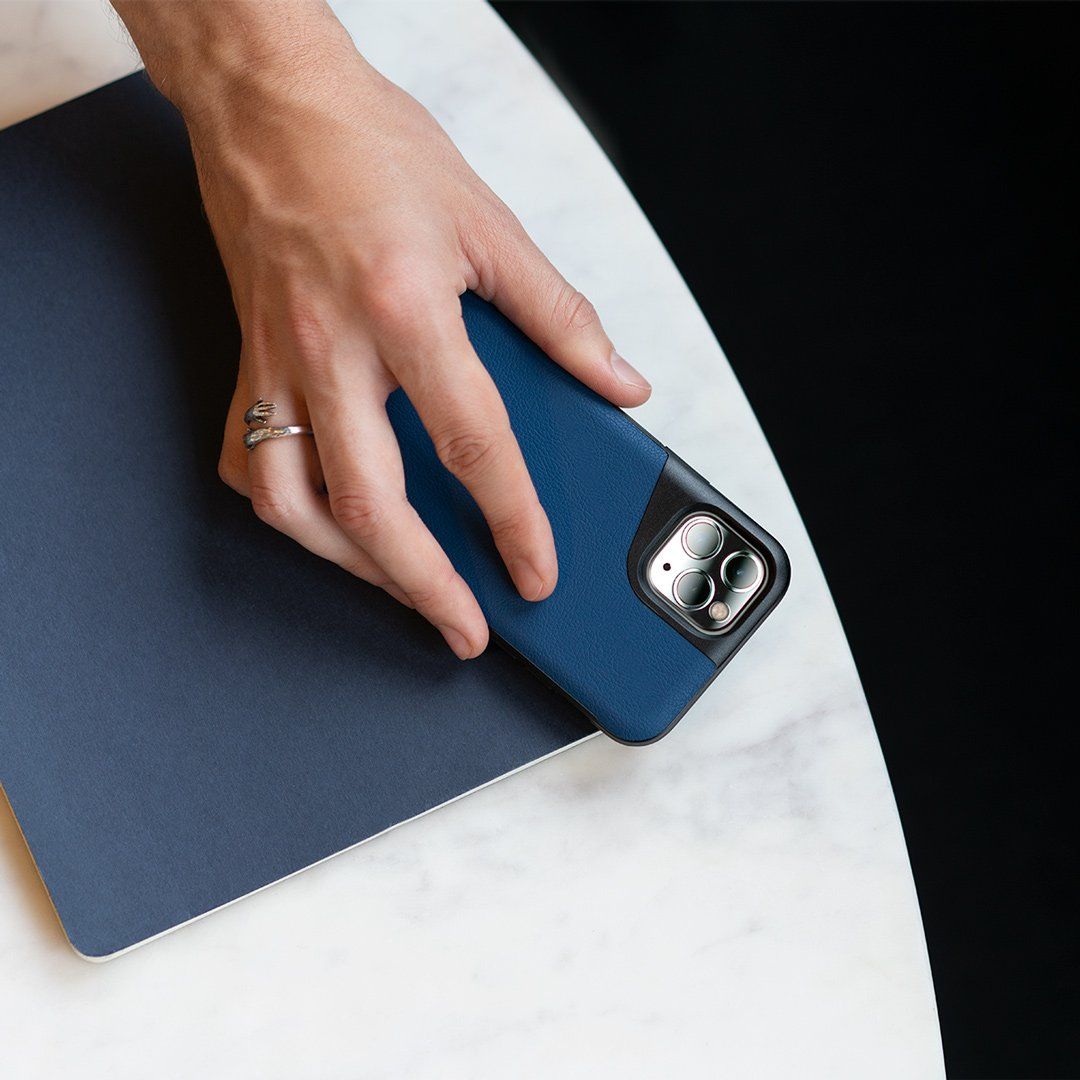 A person is holding a cell phone in a blue case