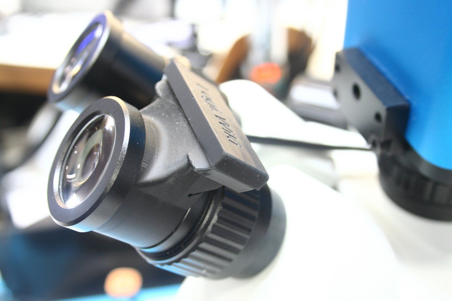 A close up of a microscope that has the 1i installed in it.