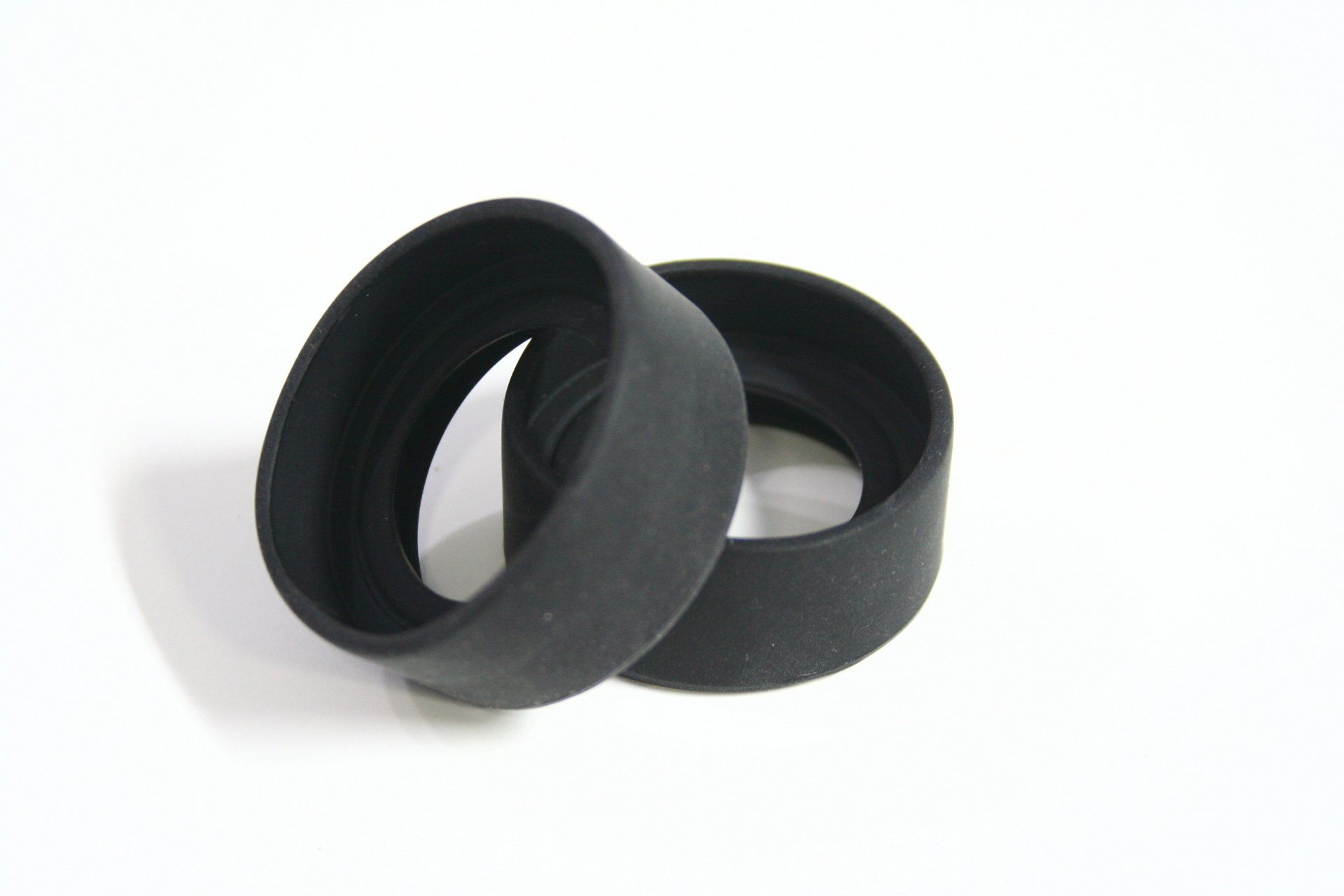 Two black rubber rings on a white surface