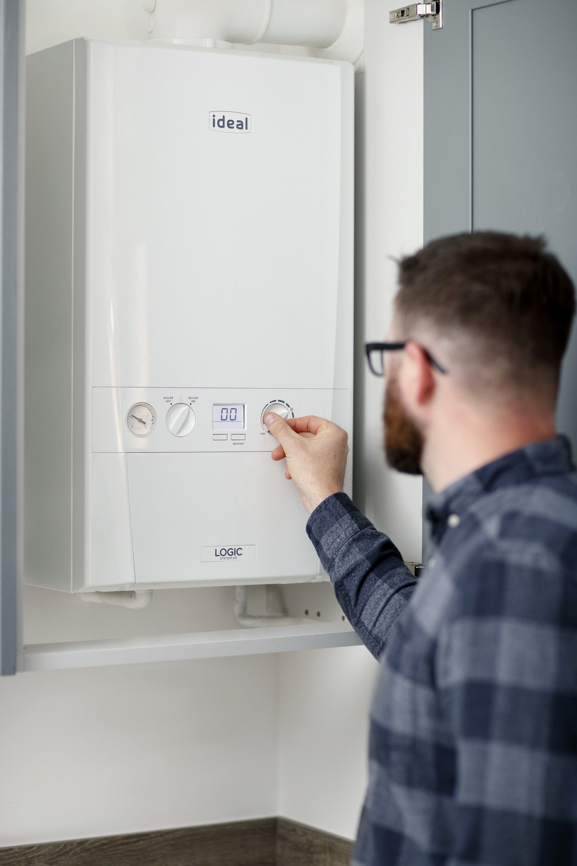 Man adjusting a boiler