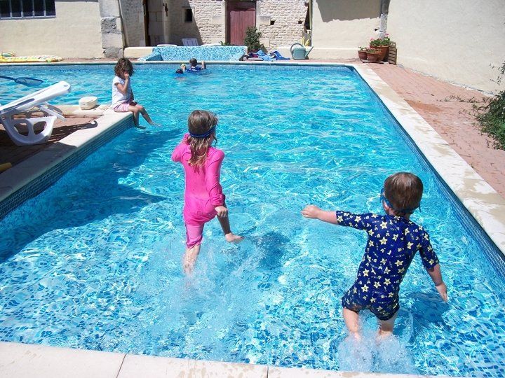 two children running into a sloping pool