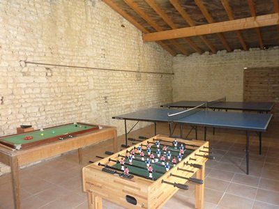 a stone barn with table football and a table tennis table