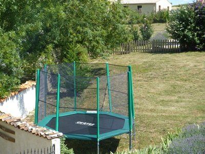 tramopline with a safety net in a garden