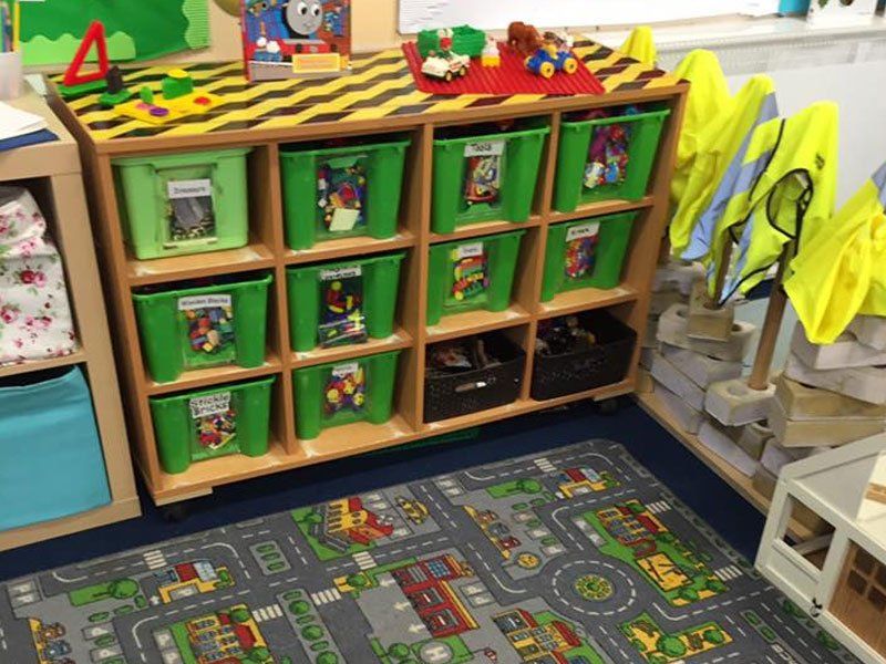 A grid of bright green storage boxes in three rows