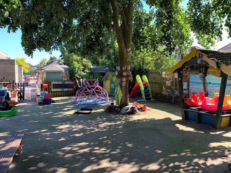 An outdoor play area with colourful play equipment and toys