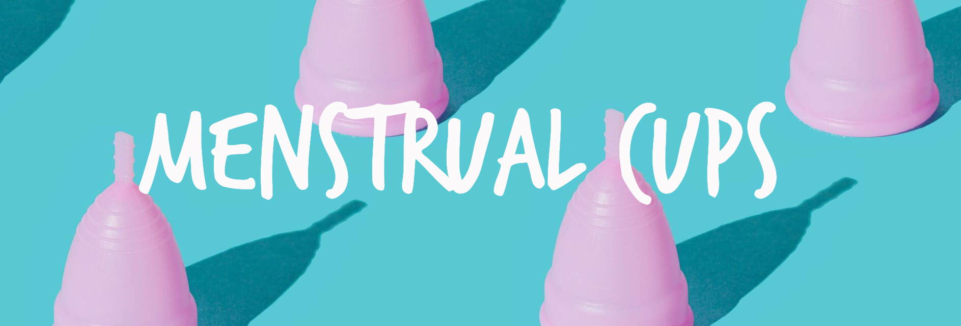 A group of pink menstrual cups sitting on top of each other on a blue surface.