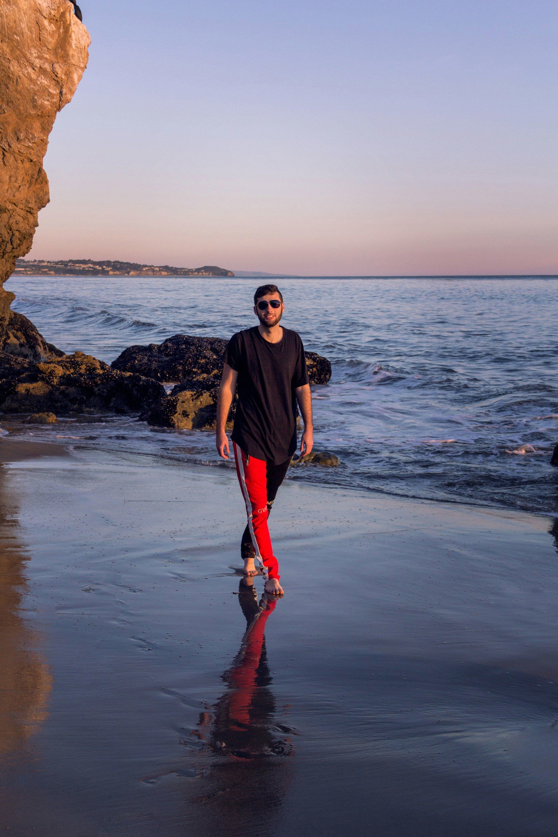 guy walking on beach