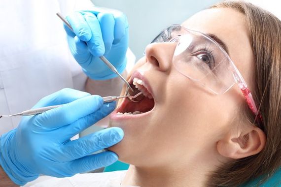 Family Dentist — Dentist Inspecting the Teeth of a Woman in Saint Peters, MO Family Dentist — Dentist Inspecting the Teeth of a Woman in Saint Peters, MO
