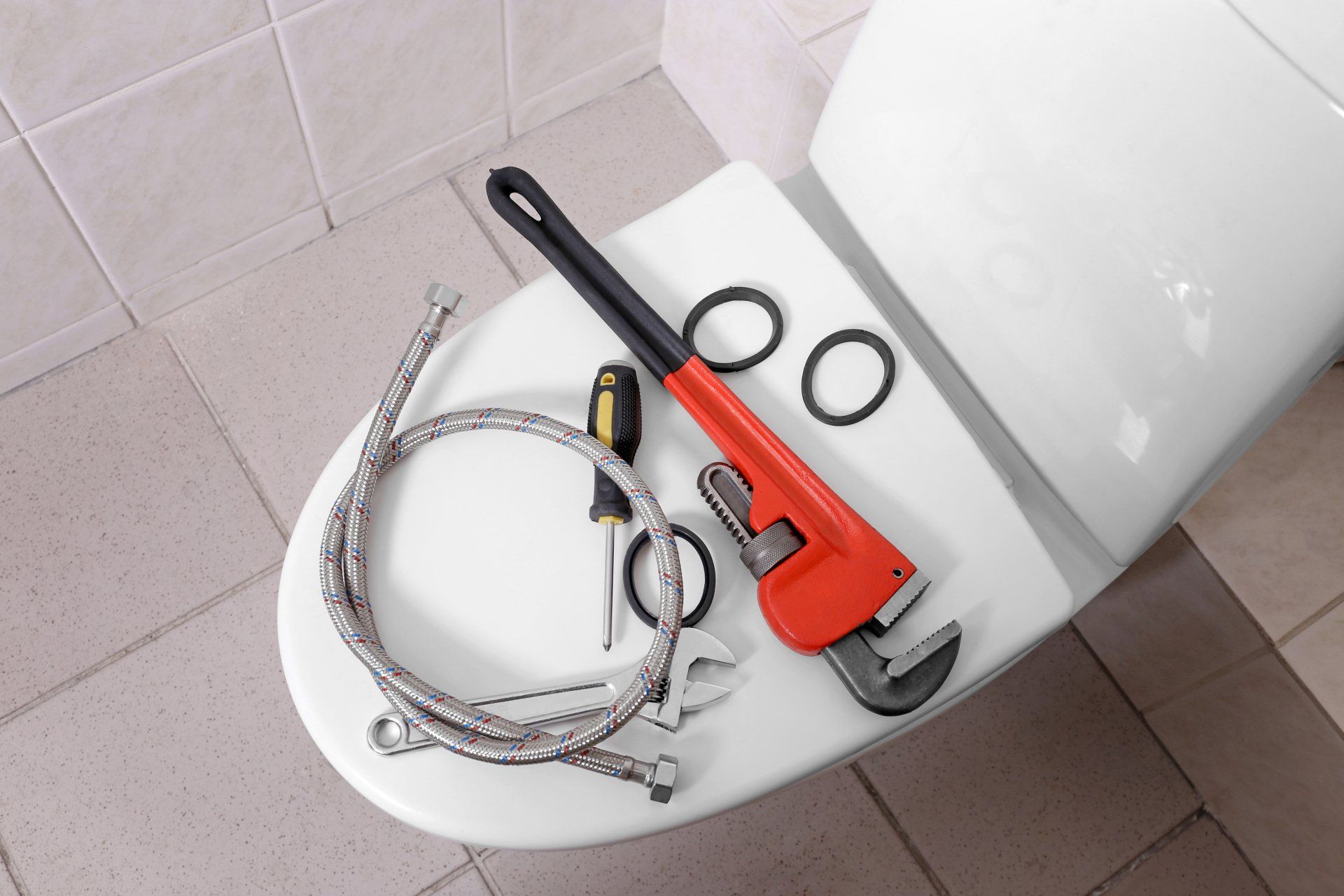 Plumber's tools on toilet at home